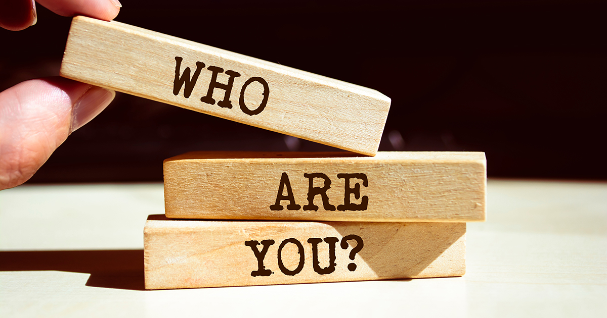 Wooden blocks spelling “Who Are You?” to represent identifying the ideal customer for a strong USP.